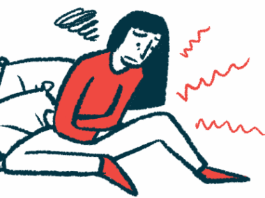 A person seated against pillows and clearly in pain crosses both arms against the belly.