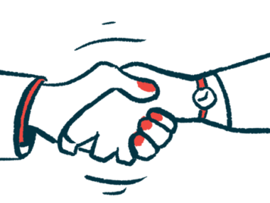 Two people's hands are seen clasped together in a handshake.