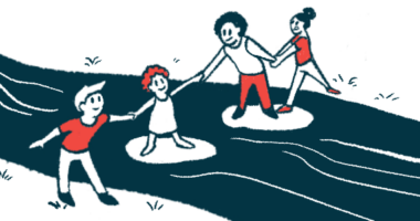 Four children hold hands as they together use stepping stones to cross a stream.